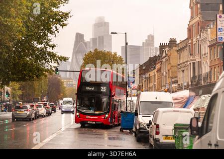 OCTOBER 29, 2025: Whitechapel Road / Royal London Hospital – City of London skyline rising above East London rooftops on a rainy autumn day Stock Photo