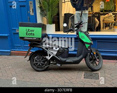 London,  United Kingdom - October 30, 2024: Uber Eats delivery scooter parked in front of a store etalage. Stock Photo