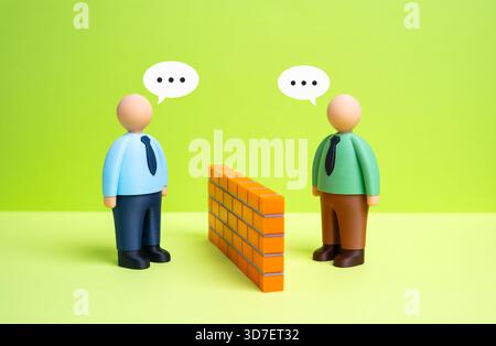 Two office workers engage in a dialogue, breaking down the barrier between them. Finding common ground. HR training, team building, and conflict resol Stock Photo