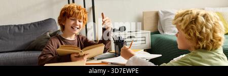 Two joyful boys share happy moments together while reading and drawing in their cozy home, banner Stock Photo