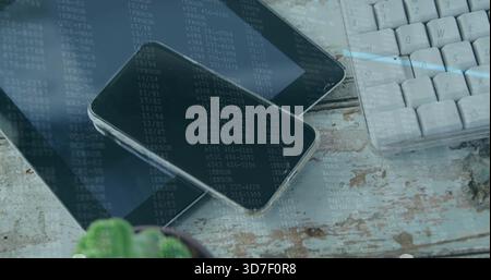 Displaying smartphone resting on tablet at home desk, showing keyboard, succulent, data overlay Stock Photo