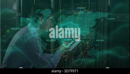 Inspecting Korean IT tech wearing light shirt tie checking tablet in data center with patch cables Stock Photo