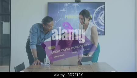 Reviewing three women in business shirts collaborating around wooden table, using laptop and tablet Stock Photo