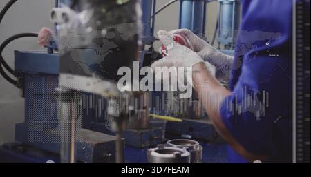 Using tech wearing blue gear and white gloves handling metal parts at workshop, with data overlay Stock Photo