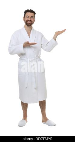 Man in bathrobe showing something on white background Stock Photo