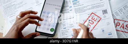 Young Woman Calculating Expenses While Analyzing Utility Bills Stock Photo