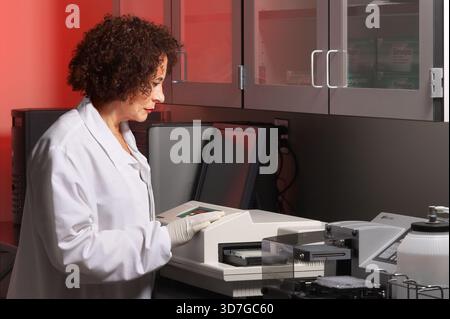 Older woman technician working in scientific laboratory, New Jersey USA Stock Photo