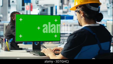 Photovoltaics factory engineer using green screen PC to adjust system parameters. Technician optimizing energy supply in solar panel manufacturing plant using chroma key computer, camera B Stock Photo