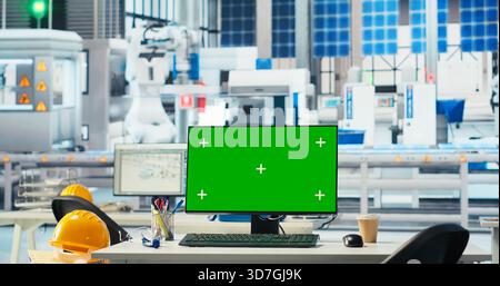 Green screen PC display in photovoltaics factory used to monitor performance during solar panels manufacturing. Mockup computer in empty facility used to inspect solar plant machinery, panning shot Stock Photo