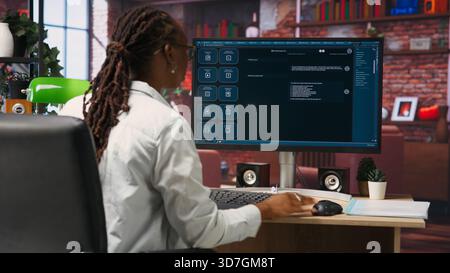 Woman at home asks questions to AI LLM chatbot virtual assistant answering user prompts. Person receiving helpful information from artificial intelligence large language model program on PC, camera B Stock Photo