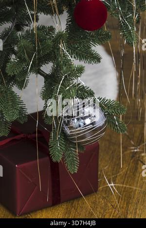 A silver ball hangs on the Christmas tree Stock Photo