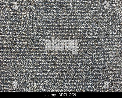 striped rough wall texture. grey concrete wall, covered with small granite crumb. Stock Photo