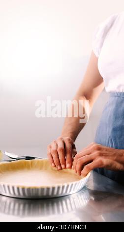 Woman preparing gluten-free apple pie for Thanksgiving celebration in kitchen. Homemade cooking, small business concept Stock Photo