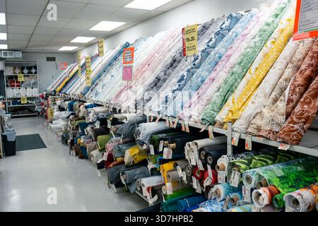 Hamilton, ON, Canada-10.23.2025: Extensive rolls of fabric are displayed in a shop environment. Stock Photo