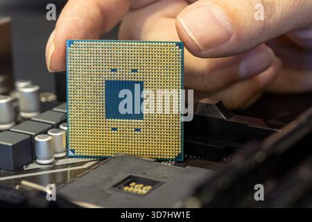 Close-up of a CPU being placed into a motherboard Stock Photo