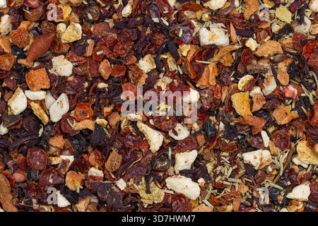 a mixture of dried fruits, herbs, and spices, commonly used for fruit tea infusions, including apple pieces, hibiscus, rose hips, and other berries. Stock Photo