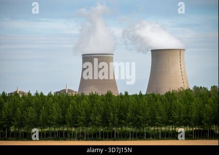 View on cooling towers of NPP, nuclear power plant thermal power station in which heat source is nuclear reactor, France, Europe, cheap energy source, Stock Photo