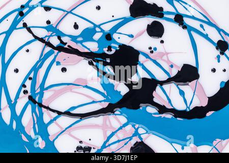 Beautiful acrylic paint pattern in three colors. Smooth lines of circles in a chaotic order. different drops of paint. Abstract modern art background Stock Photo