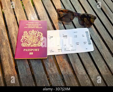 Top view travel still life featuring sunglasses boarding pass and on a wooden table passport Stock Photo
