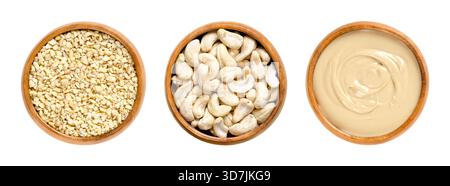 Cashews and cashew butter in wooden bowls. Chopped and whole dried seeds of shelled fruits, and roasted cashews processed into a paste. Stock Photo