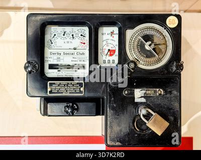 Close-up of an old British  electricity meter with dials and instructions visible on the front panel Stock Photo