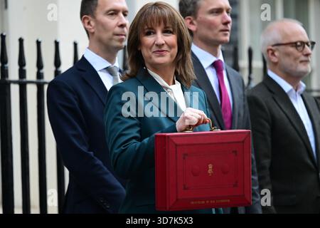 11 Downing Street, London, UK. 26th Nov, 2025. Labour Chancellor of the Exchequer Rachel Reeves MP stands outside No. 11 for the traditional press photocall holding the red despatch box containing her Budget 2025 speech to Parliament. This budget proving to be the most leaked, discussed and criticised in many years. Image: To left of Rachel Reeves is Lord Livermore, immediate right is Torsten Bell. Credit: Malcolm Park/Alamy Live News Stock Photo