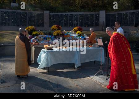 A group of Buddhist men and women priests pray as cremation urns are placed in columbariums at an An Ling service in Carmel, New York. Stock Photo