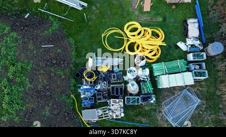 Materials for houses on a new-build housing estate, surrounded by construction equipment Stock Photo