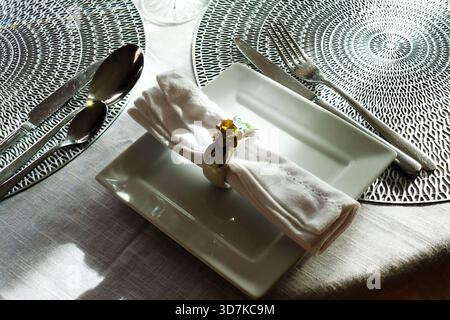 Close-up of a single napkin and napkin ring on a prepared dining table Stock Photo