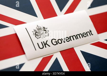 KYIV, UKRAINE - SEPTEMBER 17, 2025 Government GOV UK logotype sticker lies on UK flag close up Stock Photo