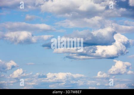 White altocumulus clouds are in blue sky on a daytime, natural background photo texture Stock Photo