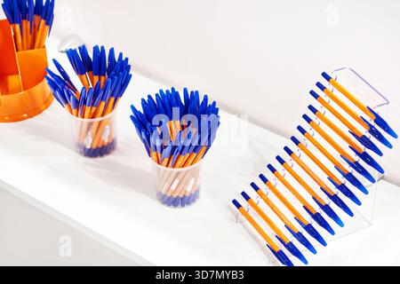 Modern colored plastic ballpoint pens on store display Stock Photo