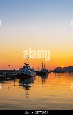 Sunset And Fishing Boats In The Harbor Of The Town Of Sassnitz On The Island Of Rügen. Stock Photo