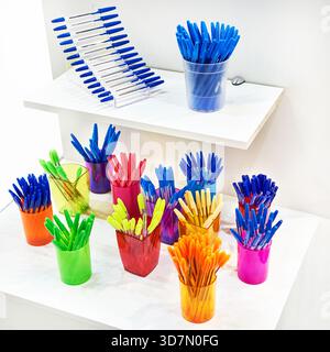 Modern colored plastic ballpoint pens on store display Stock Photo