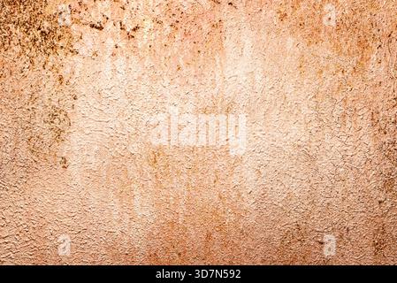 Peeling paint on rusty metal surface with rough texture and warm brown-orange tones. Ideal for grunge backgrounds and industrial design. Stock Photo