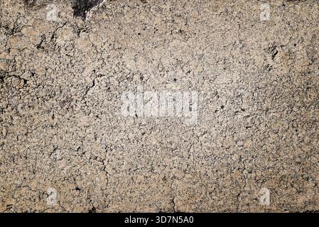 Grunge concrete texture with porous, worn, irregular surface ideal for abstract backdrops and design. Stock Photo