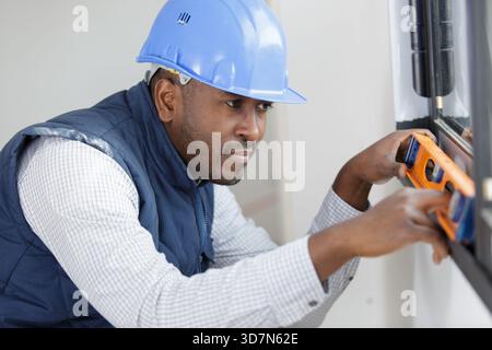 specialist for installing plastic windows checks the level Stock Photo