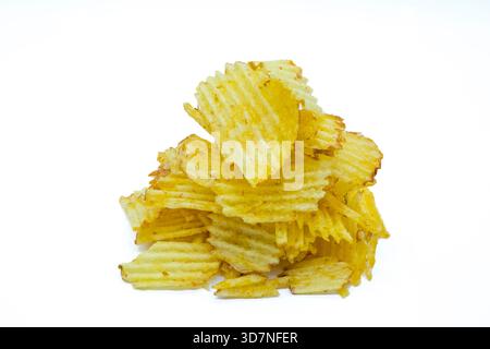 Close up of fresh crinkle cut seasoned crisps snack Stacked Ruffled Potato Chips with Golden Brown Edges Stock Photo