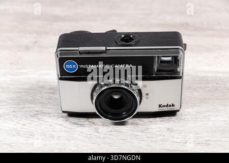 Vintage Kodak 155X Instamatic camera with black and silver body placed on a wooden surface Stock Photo