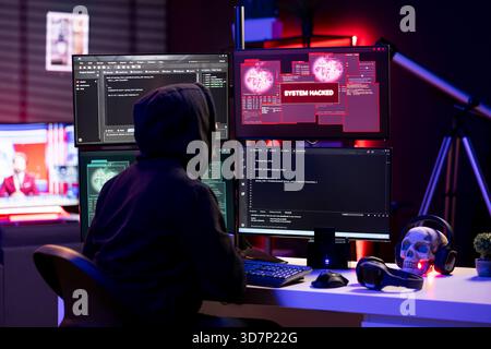 Cybercriminal receiving system hacked message after attacking victims PCs using computer virus. Lone wolf hacker in secret lair trying to hide online activity after stealing data Stock Photo