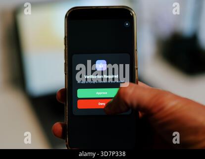 Man Uses Two Factor Authentication to Authorize Application Access Basic Enterprise Information Securtity Concept - 2FA MFA Mobile App Stock Photo
