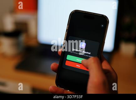 Man Uses Two Factor Authentication to Authorize Application Access Basic Enterprise Information Securtity Concept - 2FA MFA Mobile App Stock Photo