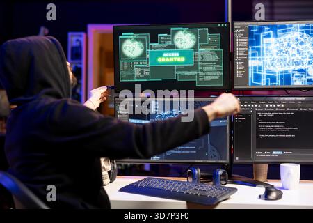 Hacker inserting USB stick in PC with undetectable malware used to get access granted past antivirus protection. Cybercriminal uploading flash drive with data scraper app used to breaching firewalls Stock Photo