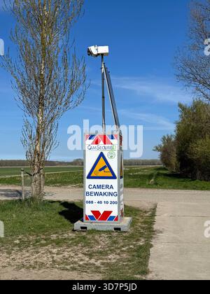 Almere, the Netherlands - April 8, 2025: Camsecure security camera unit against a partly clouded sky. Stock Photo