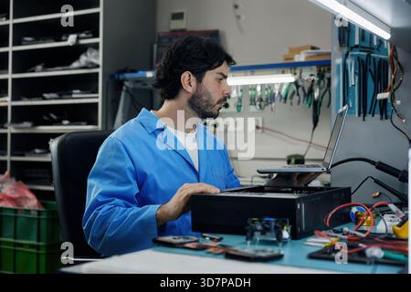 A man soldering technician is repairing computer Stock Photo