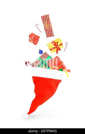 Santa hat overflowing with Christmas gifts, ornaments, and candy canes, dynamically falling/isolated on white. High quality photo Stock Photo