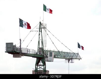 Mexican flags on a construction crane Stock Photo