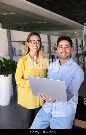 Two happy young professional partners standing together Stock Photo