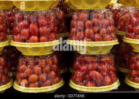 Packaged Cherry Tomatoes Stacked in Grocery Store Produce Section Stock Photo