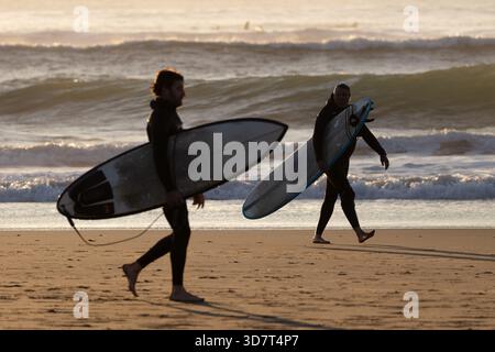 Surfers Walking with Boards on Ocean Beach in San Francisco Stock Photo